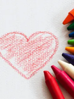drawing of heart with half circle of crayons