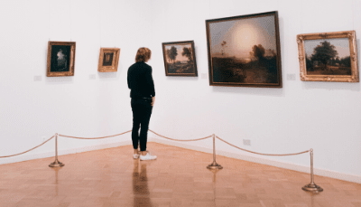 man looking at art in a museum