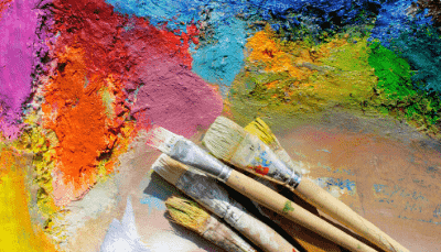blotches of paint with paintbrushes