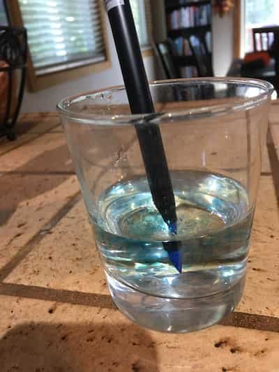 blue brush pen in water