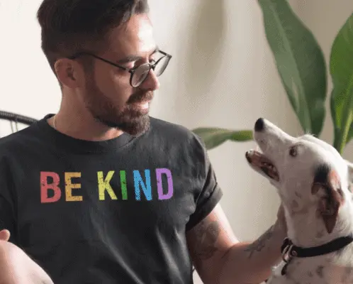 man with be kind shirt and dog