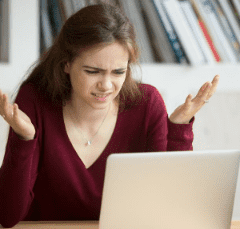 woman confused at laptop