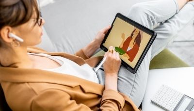 woman drawing on tablet with stylus