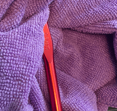 cleaning a crochet hook with a cloth